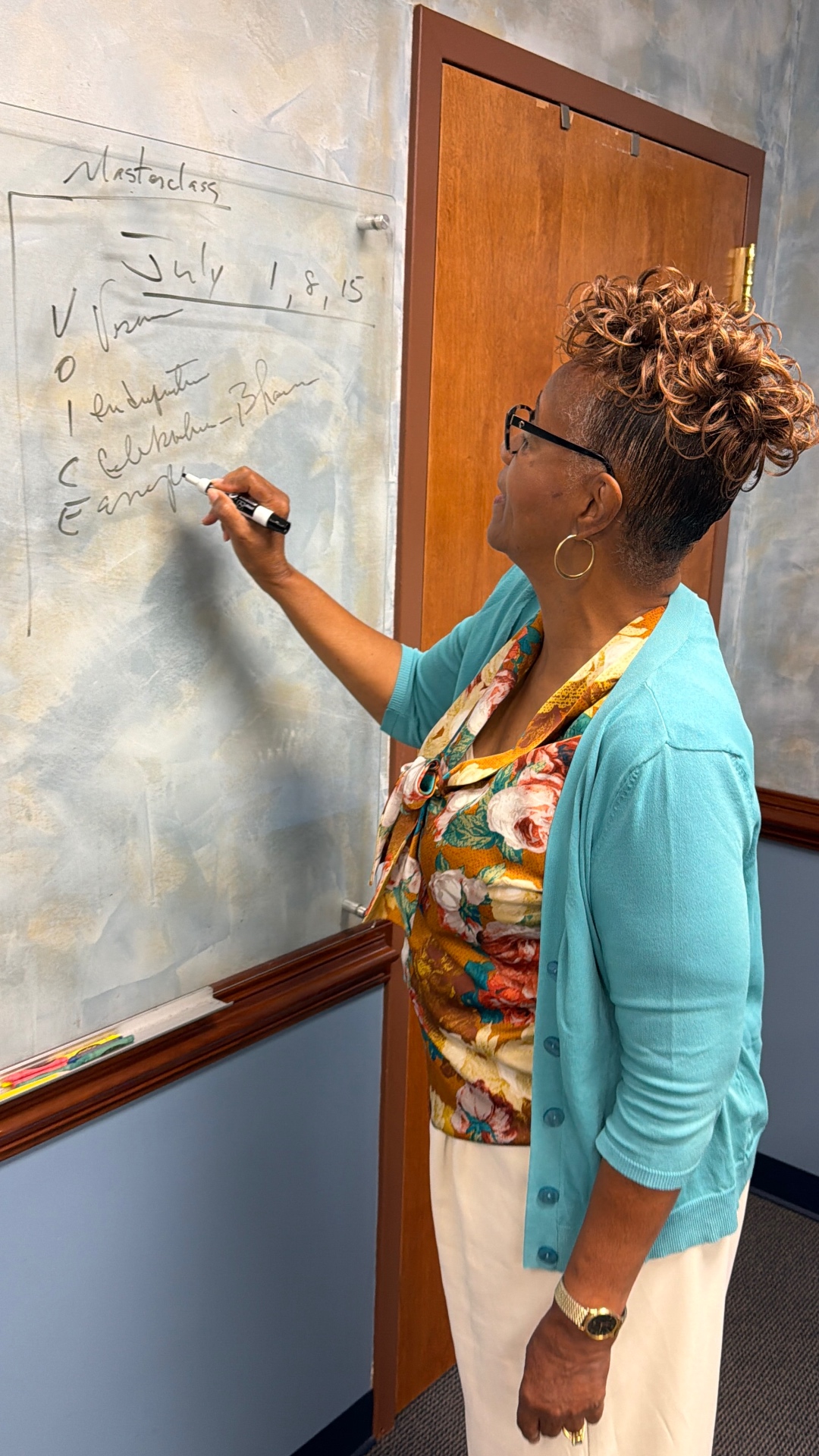 Dr. Vanessa Owens writing V.O.I.C.E. dates on the whiteboard
